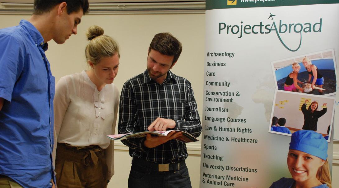 Projects Abroad staff talk to potential volunteers during an information event. Leads have the volunteer projects and internships explained during an event.